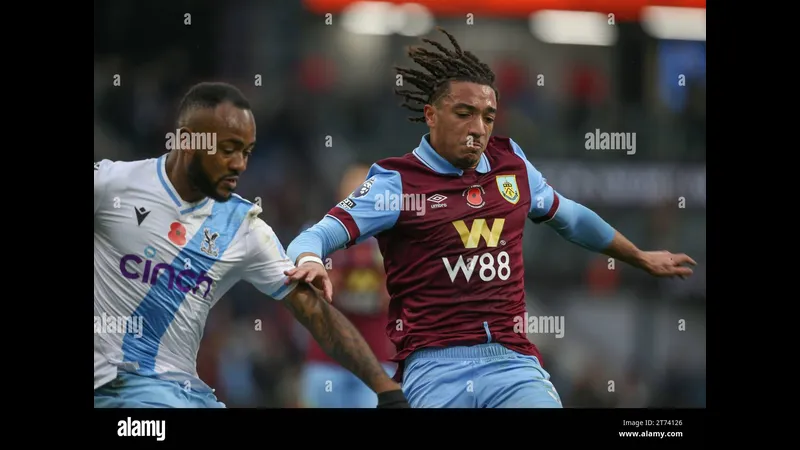 Cầu thủ Burnley đang tấn công dẫn bóng trước sự áp sát của cầu thủ Crystal Palace